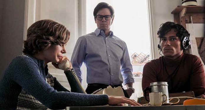 The kidnappers call a distraught Gail (Michelle Williams) threatening to harm Paul if they are not paid while Fletcher Chace (Mark Wahlberg, center) overlooks in TriStar Pictures' ALL THE MONEY IN THE WORLD.