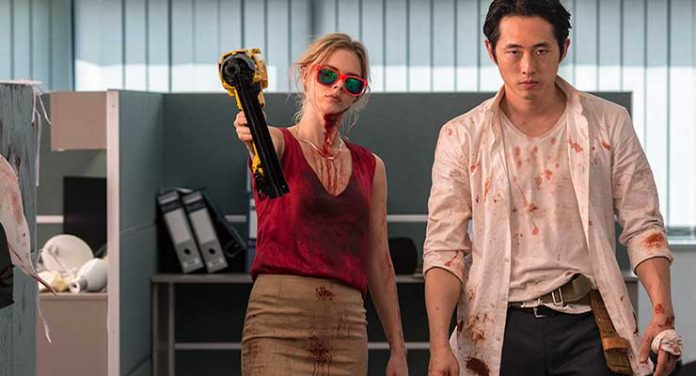 (L-R) Samara Weaving as Melanie Cross and Steven Yeun as Derek Cho in the horror, action film MAYHEM an RLJE Films release. Photo courtesy of Sanja Bucko.