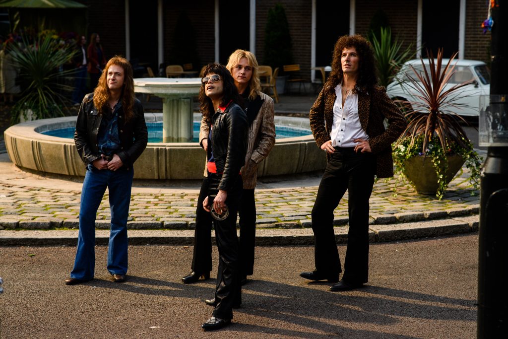 BOHEMIAN RHAPSODY L-R: Joe Mazzello (John Deacon), Rami Malek (Freddie Mercury), Ben Hardy (Roger Taylor), and Gwilym Lee (Brian May) star in Twentieth Century Fox’s BOHEMIAN RHAPSODY. Photo Credit: Alex Bailey.