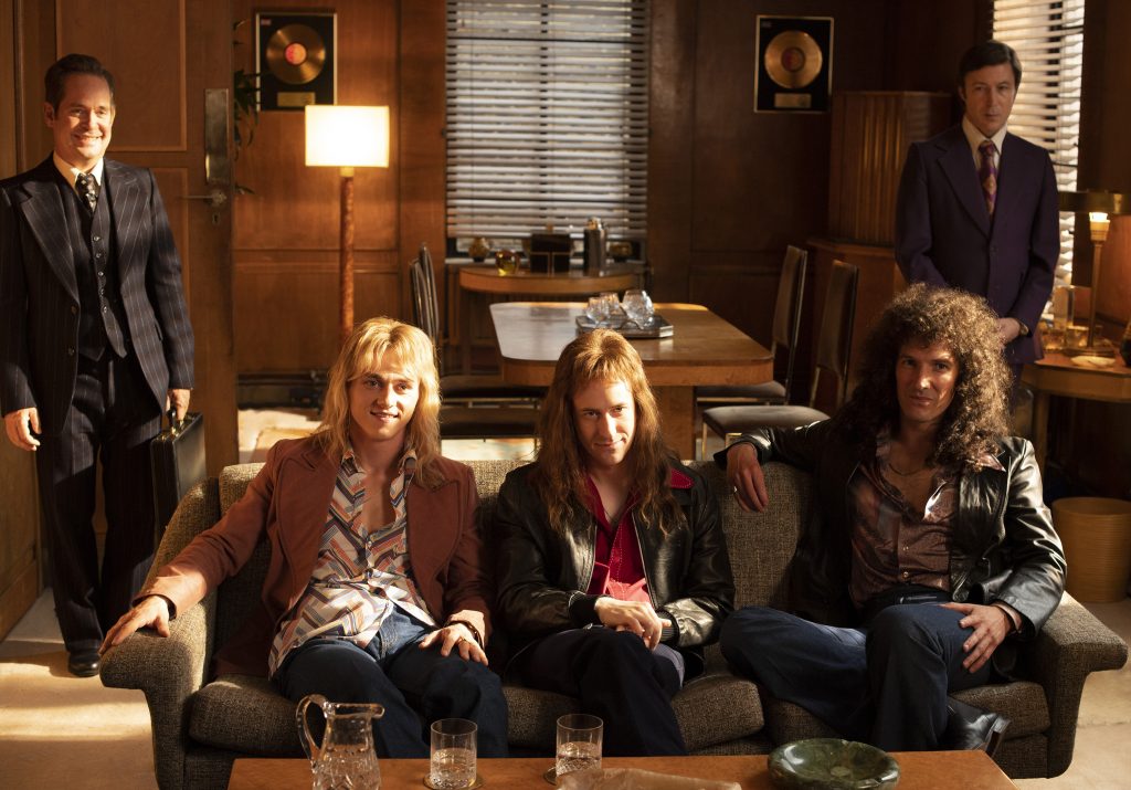 BOHEMIAN RHAPSODY L-R: Tom Hollander (Jim Beach), Ben Hardy (Roger Taylor), Joe Mazzello (John Deacon), Gwilym Lee (Brian May), and Aidan Gillen (John Reid) in Twentieth Century Fox’s BOHEMIAN RHAPSODY. Photo Credit: Alex Bailey.
