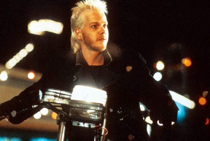 Kiefer Sutherland riding a motorcycle in a scene from the film 'The Lost Boys', 1987. (Photo by Warner Brothers/Getty Images)