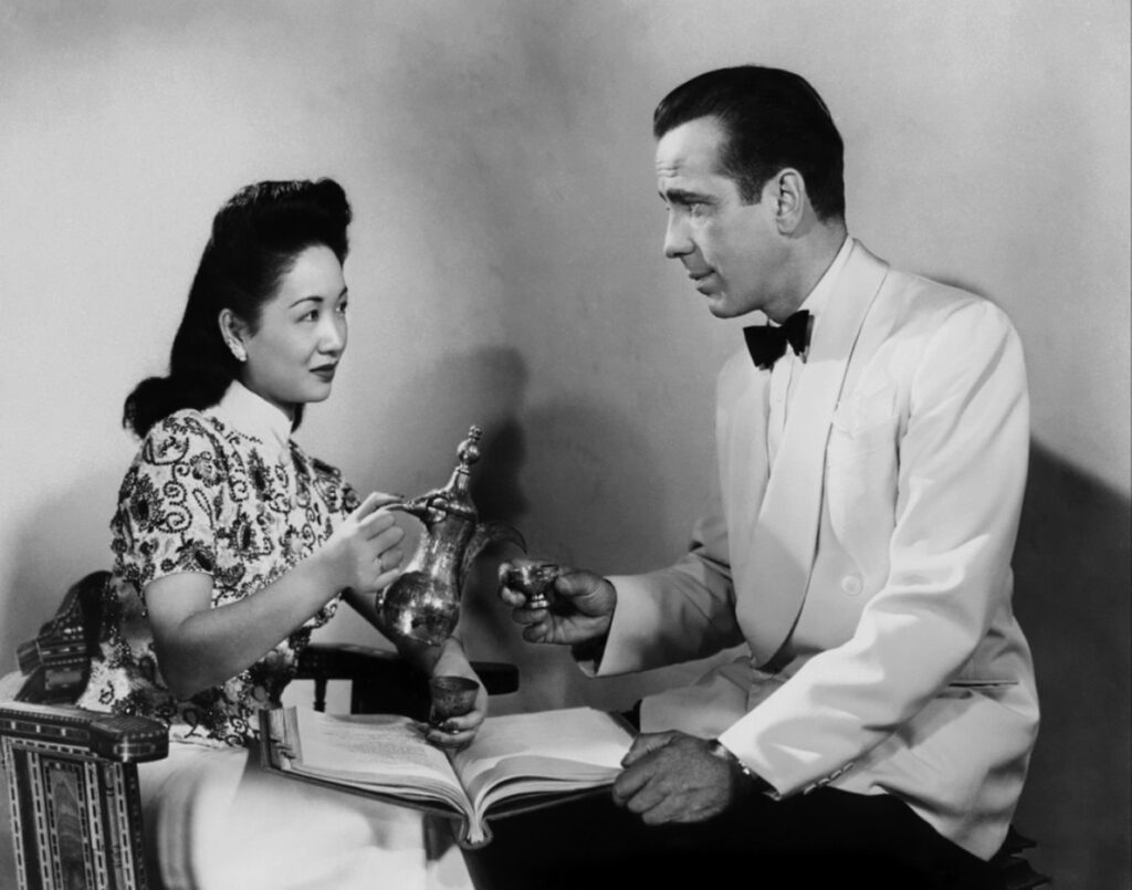 LOS ANGELES - 1942: Actors Humphrey Bogart and Melie Chang pose for a publicity still for the Warner Bros film 'Casablanca' in 1942 in Los Angeles, California. (Photo by Donaldson Collection/Michael Ochs Archives/Getty Images)