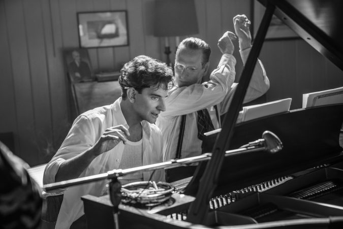 Maestro. (L to R) Bradley Cooper as Leonard Bernstein (Director/Writer/Producer), and Brian Klugman as Aaron Copland in Maestro. Cr. Courtesy of Netflix © 2023.